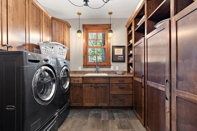 washroom featuring cabinets, washer and clothes dryer, and sink