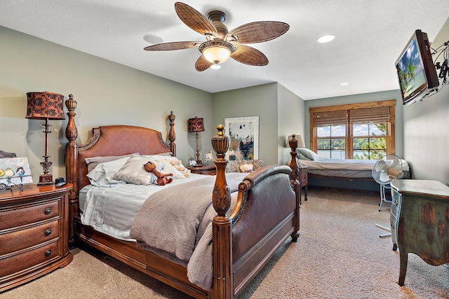 bedroom with ceiling fan and light carpet