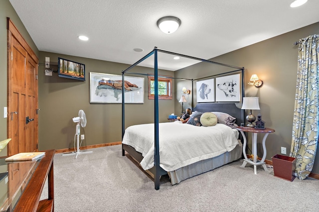 bedroom featuring carpet floors and a textured ceiling