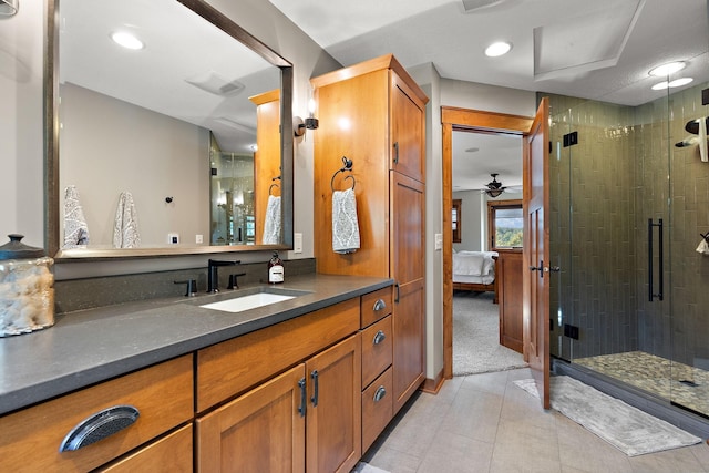 bathroom with tile patterned floors, vanity, and a shower with door