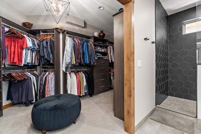 spacious closet featuring light colored carpet