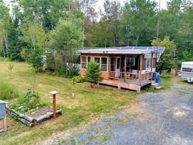 rear view of house with a yard and a deck