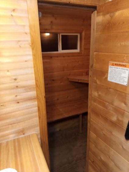 view of sauna / steam room featuring wood walls