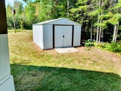 view of outdoor structure with a lawn