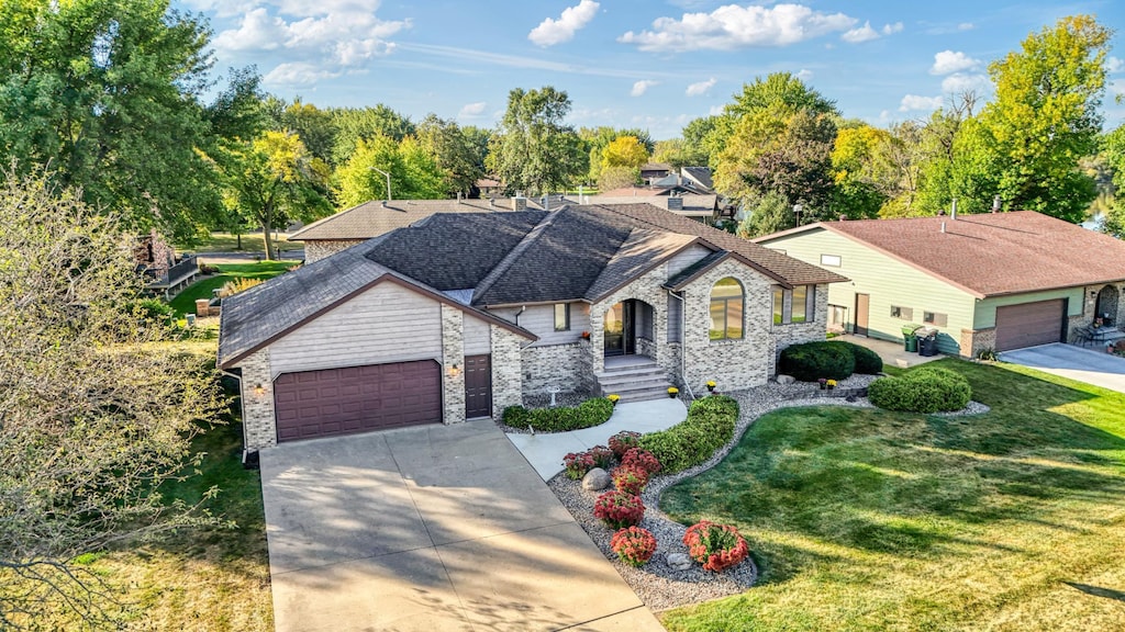 view of front of home featuring a garage and a front lawn