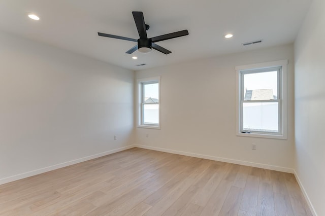 unfurnished room featuring ceiling fan, a healthy amount of sunlight, and light wood-type flooring