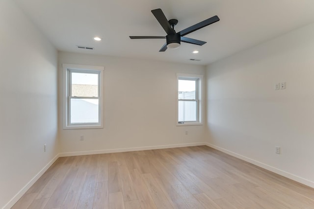 spare room featuring light wood-type flooring and ceiling fan