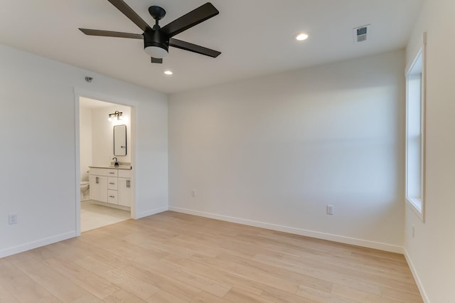 unfurnished bedroom with connected bathroom, ceiling fan, light hardwood / wood-style flooring, and sink