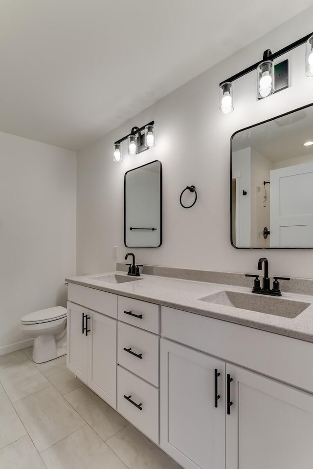 bathroom featuring tile patterned floors, vanity, and toilet