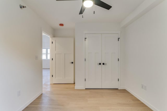 unfurnished bedroom with ceiling fan, light hardwood / wood-style floors, and a closet