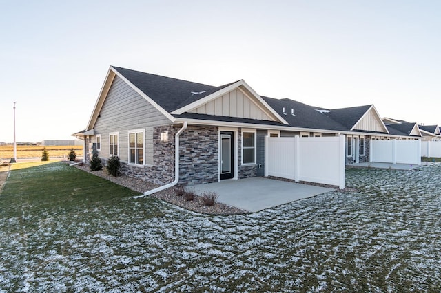 rear view of house with a yard and a patio area