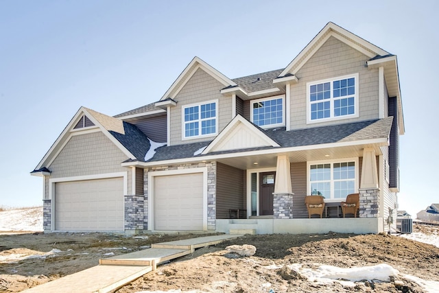 craftsman-style house with covered porch and a garage