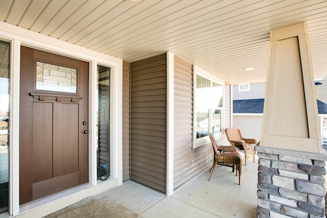 view of exterior entry with covered porch