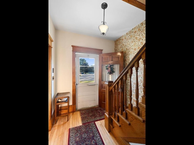 doorway to outside with light wood-type flooring