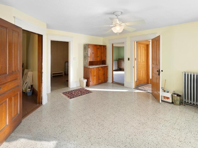 interior space featuring radiator heating unit and ceiling fan