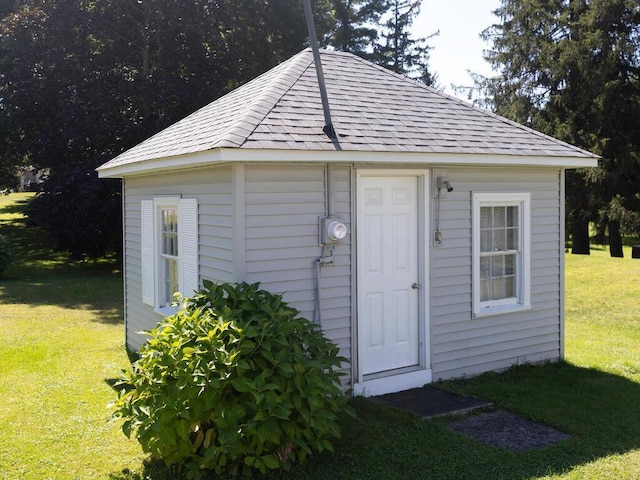 view of outbuilding featuring a lawn