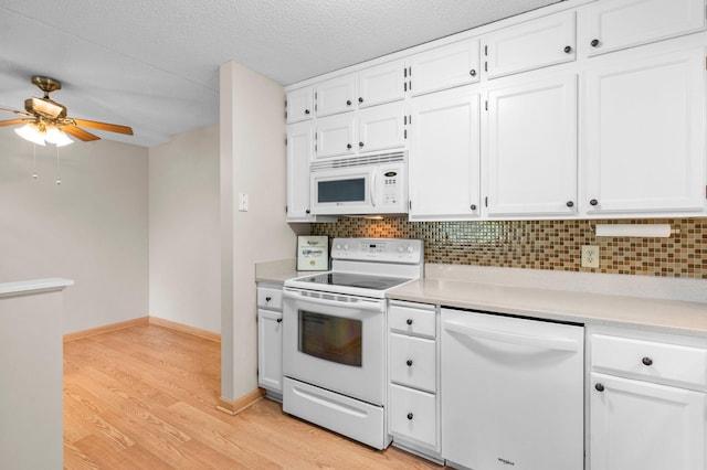 kitchen featuring white appliances, tasteful backsplash, ceiling fan, white cabinets, and light hardwood / wood-style floors