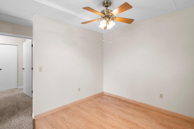 empty room featuring light hardwood / wood-style flooring and ceiling fan