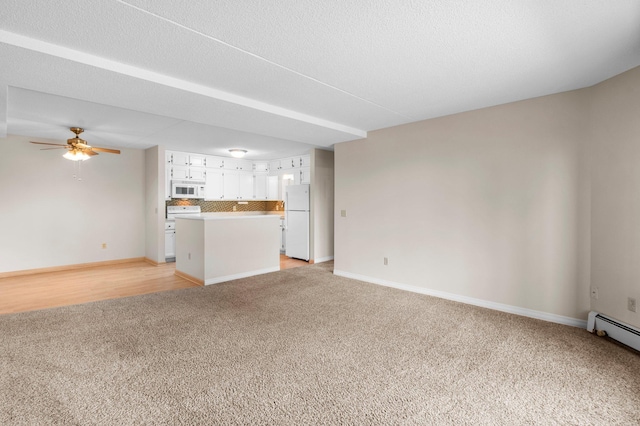 unfurnished living room with a baseboard heating unit, light colored carpet, ceiling fan, and a textured ceiling