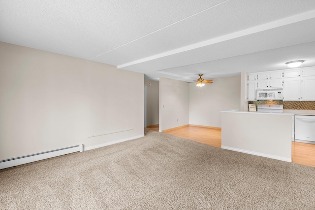 unfurnished living room with a baseboard heating unit, light colored carpet, ceiling fan, and a textured ceiling