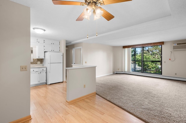 kitchen featuring light wood-type flooring, white refrigerator, ceiling fan, and decorative backsplash