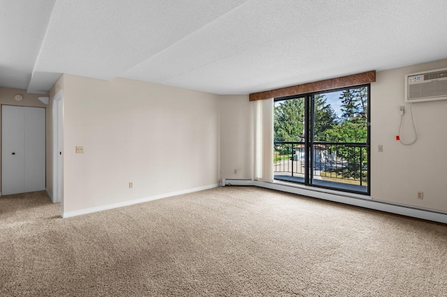 empty room featuring a textured ceiling, an AC wall unit, a baseboard radiator, and carpet flooring