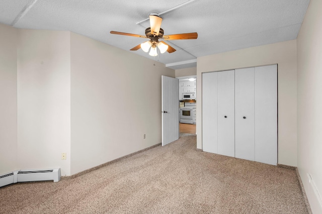 unfurnished bedroom featuring light carpet, a textured ceiling, ceiling fan, and a closet