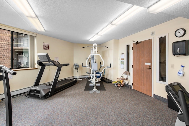 workout area featuring carpet floors and a textured ceiling