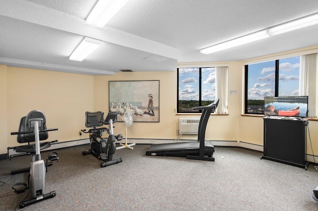 workout area featuring a textured ceiling, carpet flooring, a wall unit AC, and a baseboard radiator