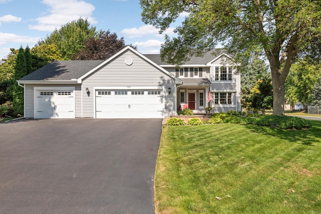 view of front of house with a front lawn and a garage