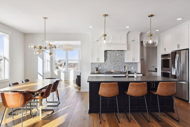 kitchen featuring an island with sink, a healthy amount of sunlight, and stainless steel appliances