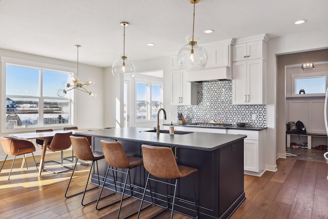 kitchen featuring wood-type flooring, plenty of natural light, and sink