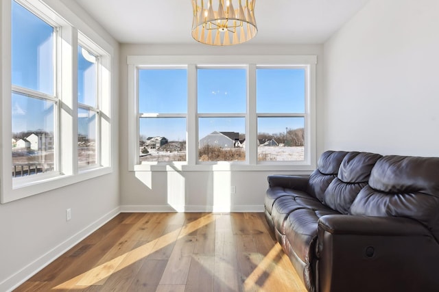 living room with hardwood / wood-style floors and a chandelier