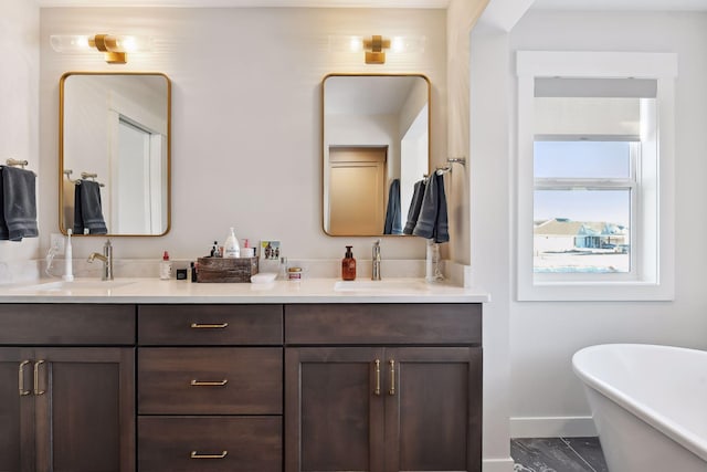 bathroom with a tub to relax in and vanity