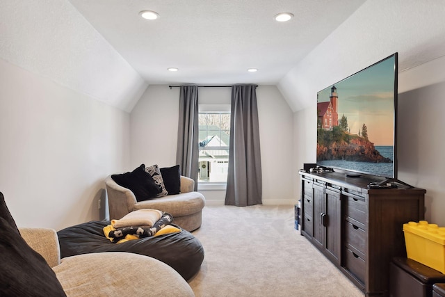 living room featuring light colored carpet, a textured ceiling, and vaulted ceiling