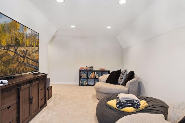 sitting room featuring light colored carpet and vaulted ceiling