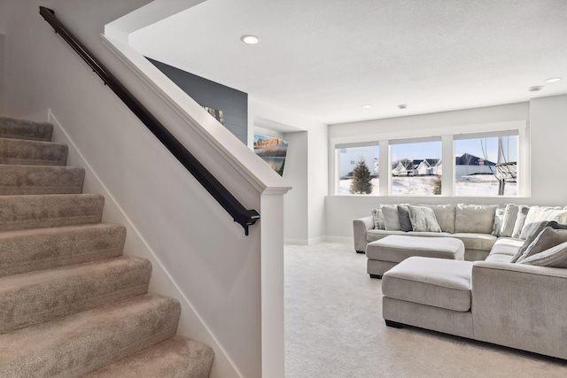 living room featuring a textured ceiling and light colored carpet