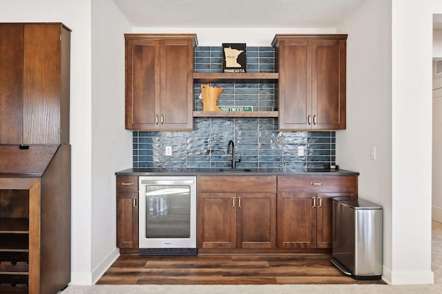 bar with a textured ceiling, tasteful backsplash, wine cooler, and dark hardwood / wood-style floors