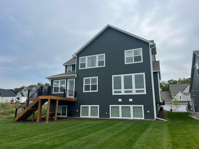 back of property with a yard, a garage, and a deck