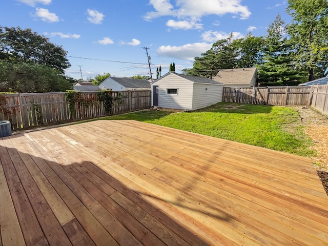 wooden terrace featuring a lawn, a storage unit, and central air condition unit