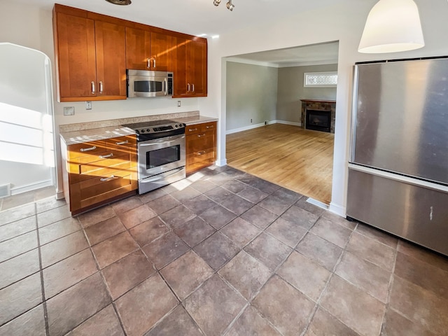 kitchen featuring appliances with stainless steel finishes and dark hardwood / wood-style flooring