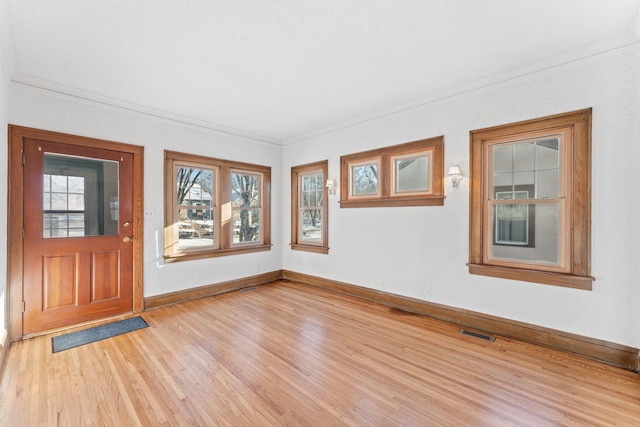 entryway featuring light hardwood / wood-style floors and ornamental molding