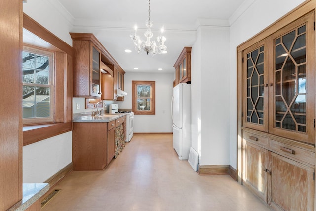 kitchen featuring an inviting chandelier, ornamental molding, pendant lighting, and white appliances