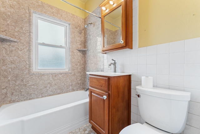 full bathroom featuring tiled shower / bath combo, tile patterned floors, vanity, tile walls, and toilet