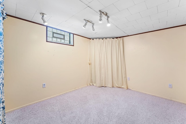 basement featuring crown molding and carpet floors