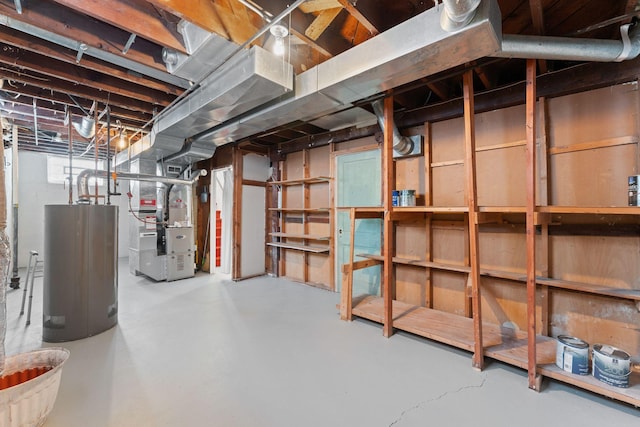 basement featuring water heater and heating unit