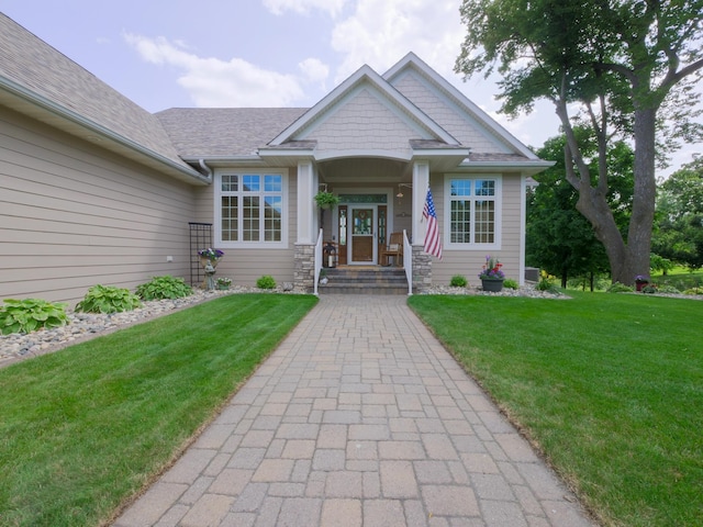 4424 Donway Dr NE, Alexandria, MN 56308 - view of front of property with a front yard, stone siding, and roof with shingles