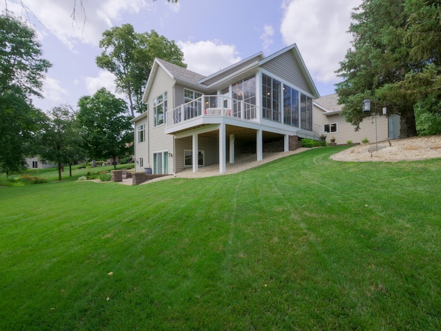 4424 Donway Dr NE, Alexandria, MN 56308 - rear view of house with a sunroom, a yard, a shingled roof, and a wooden deck