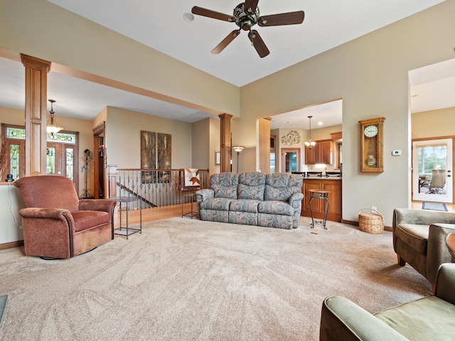 4424 Donway Dr NE, Alexandria, MN 56308 - living room featuring light colored carpet, decorative columns, ceiling fan, and plenty of natural light