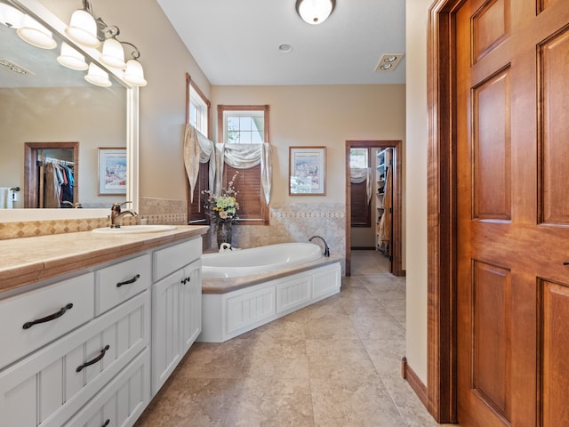 4424 Donway Dr NE, Alexandria, MN 56308 - full bathroom with vanity, a spacious closet, and a bath